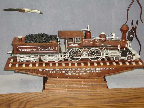 Picture of The Commodore Vanderbilt <br>one of the trains Mr. Warther carved. <br>Also, a knife and tools can be seen in the background.